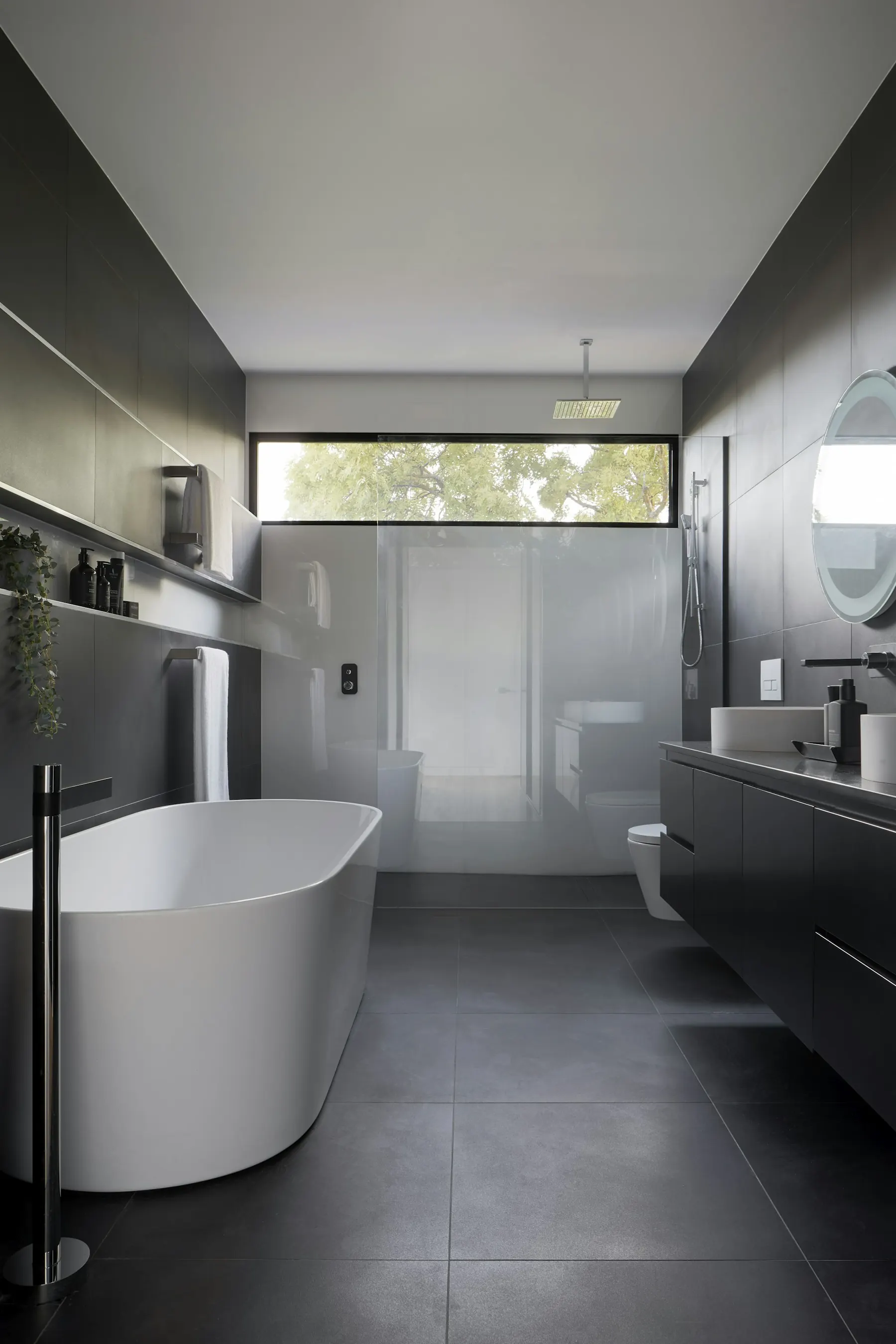 Bathroom with freestanding tub and grey stone finishes