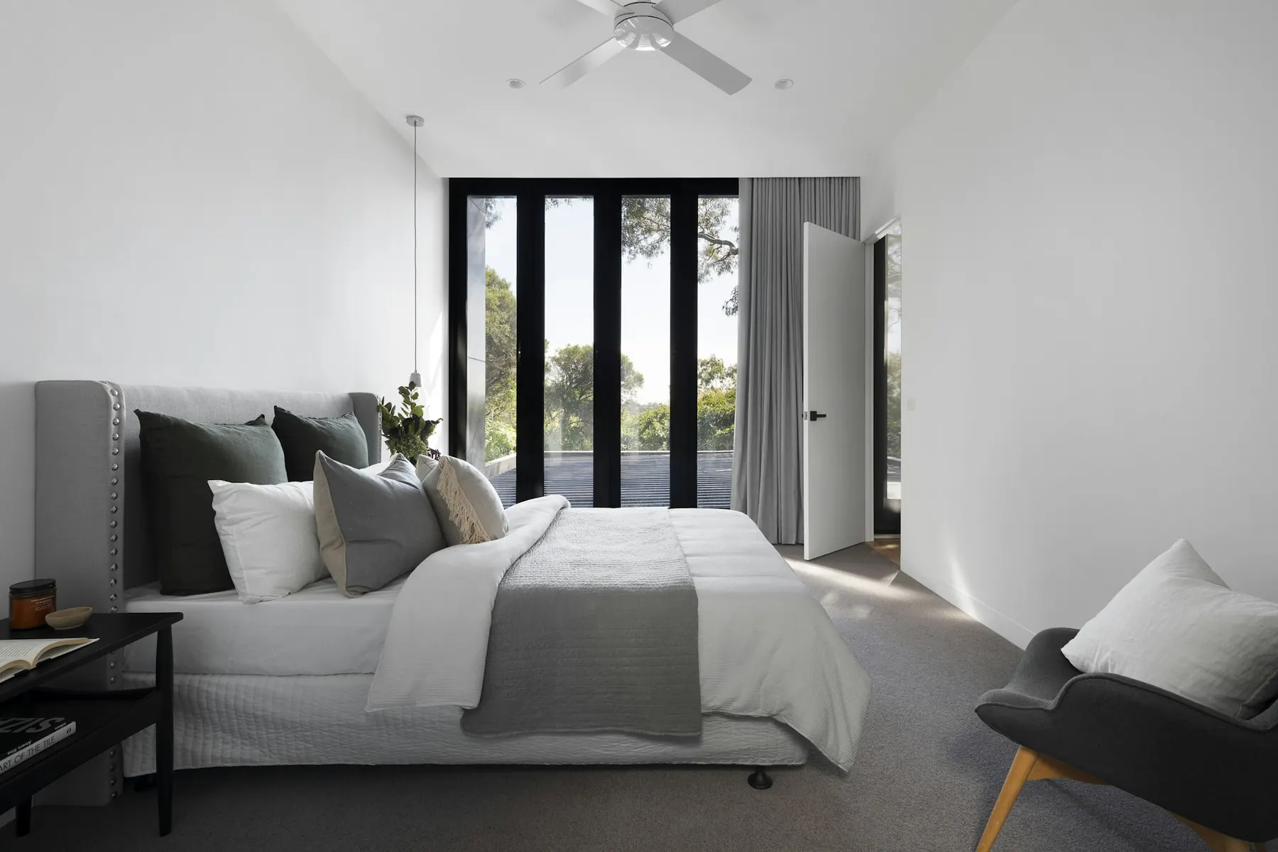 Bedroom with neutral linen and tall glazed doors