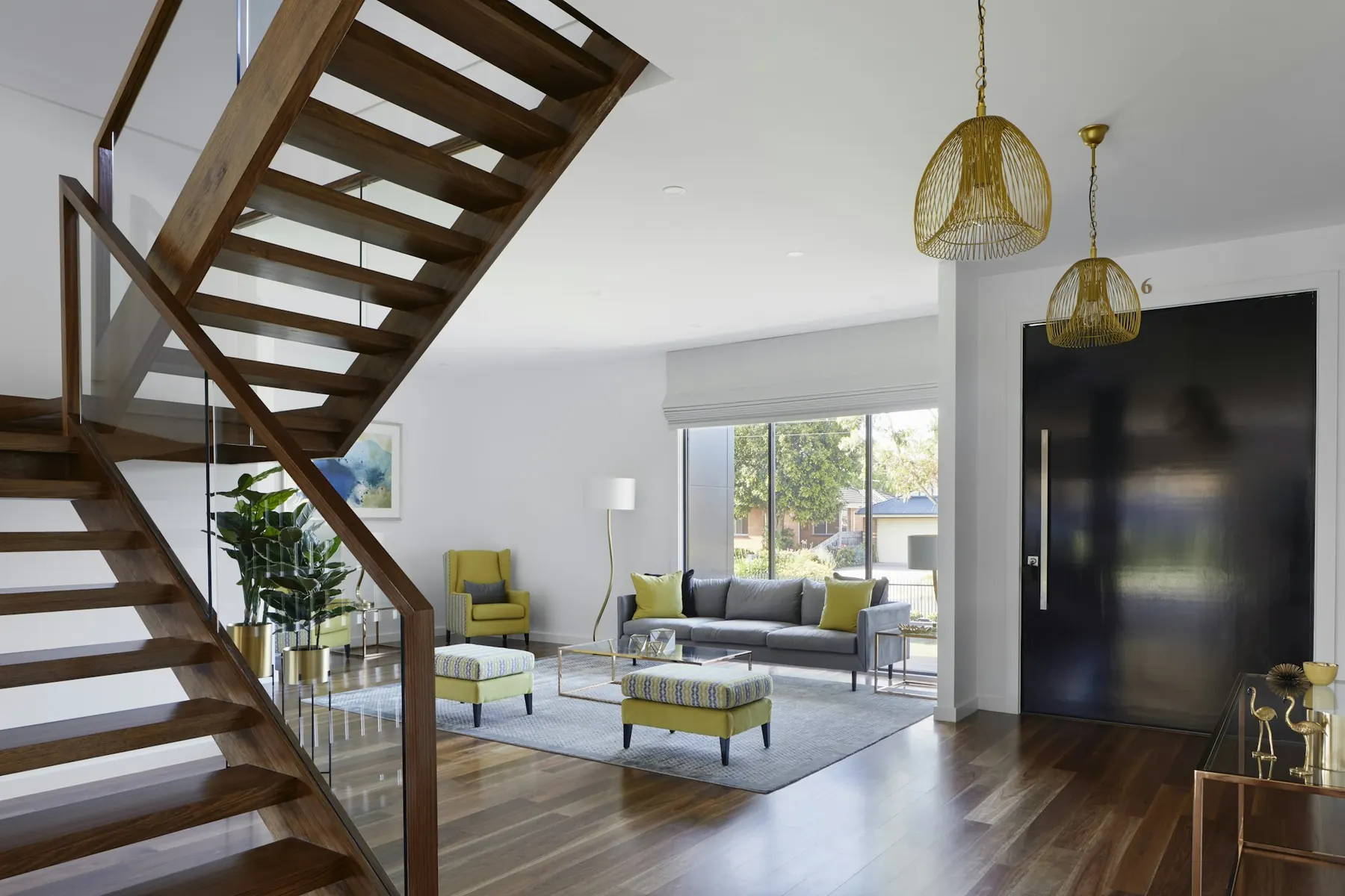 Timber staircase in a bright double-height hall
