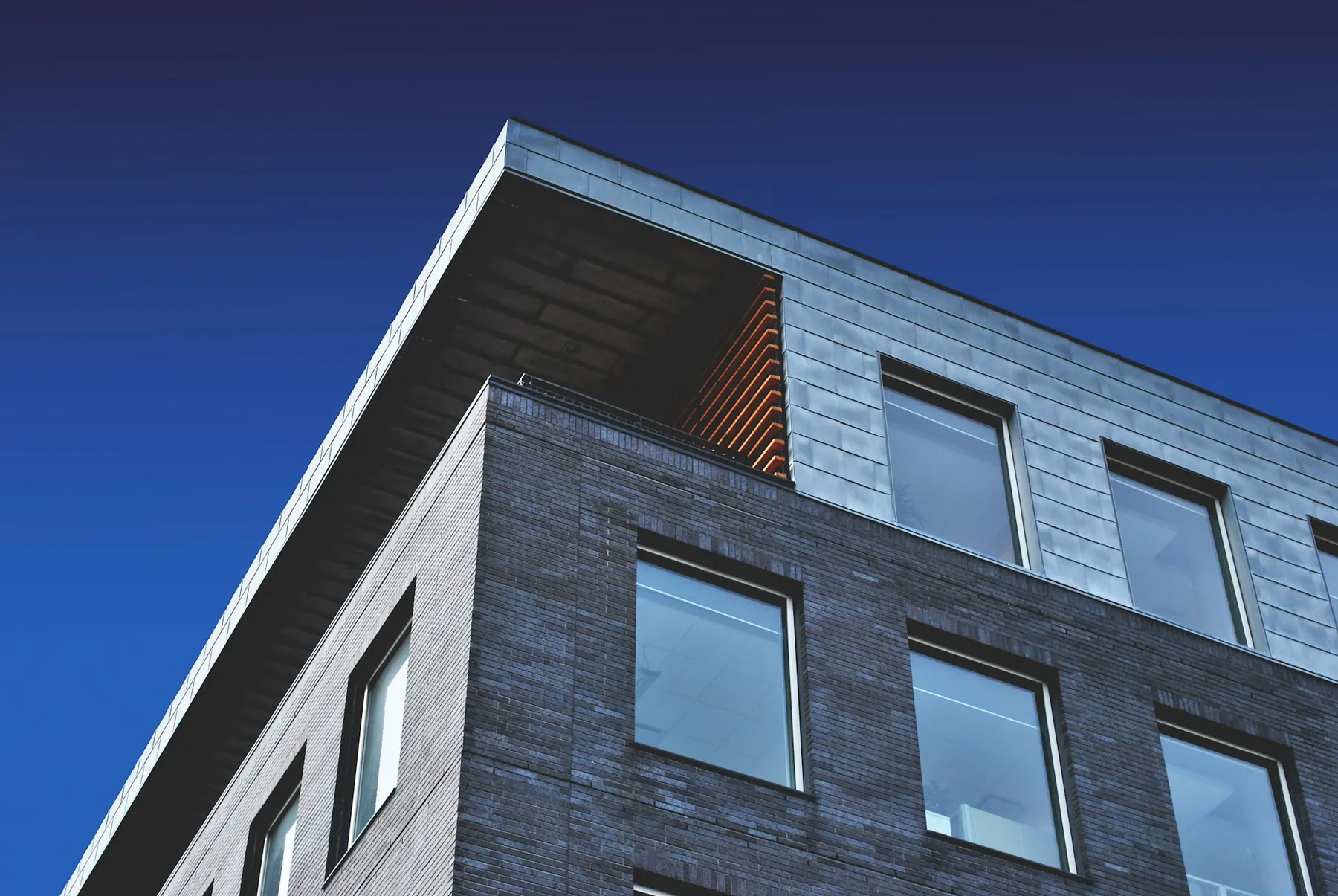 Modern office building façade against a blue sky