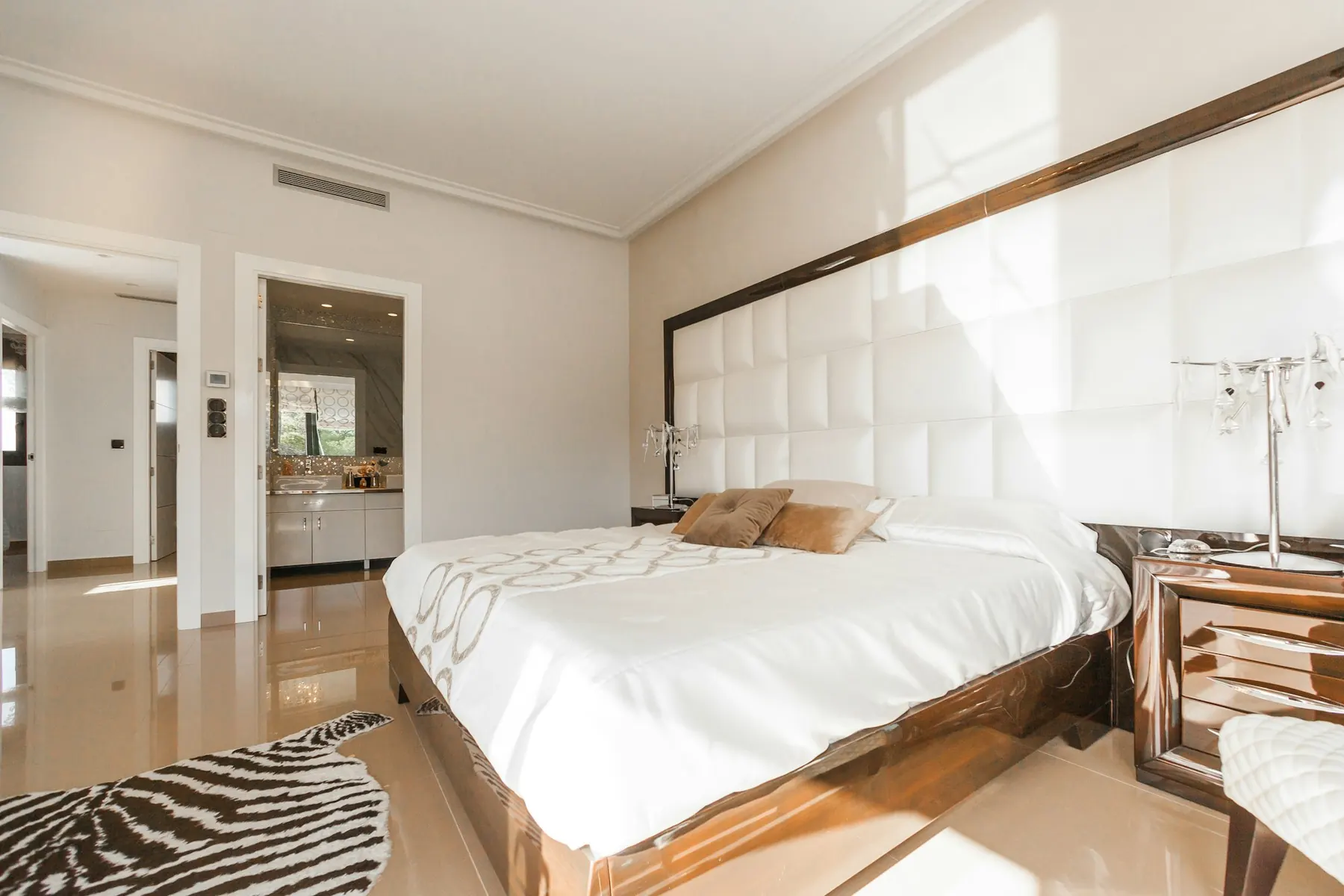 Bedroom with upholstered headboard and soft light