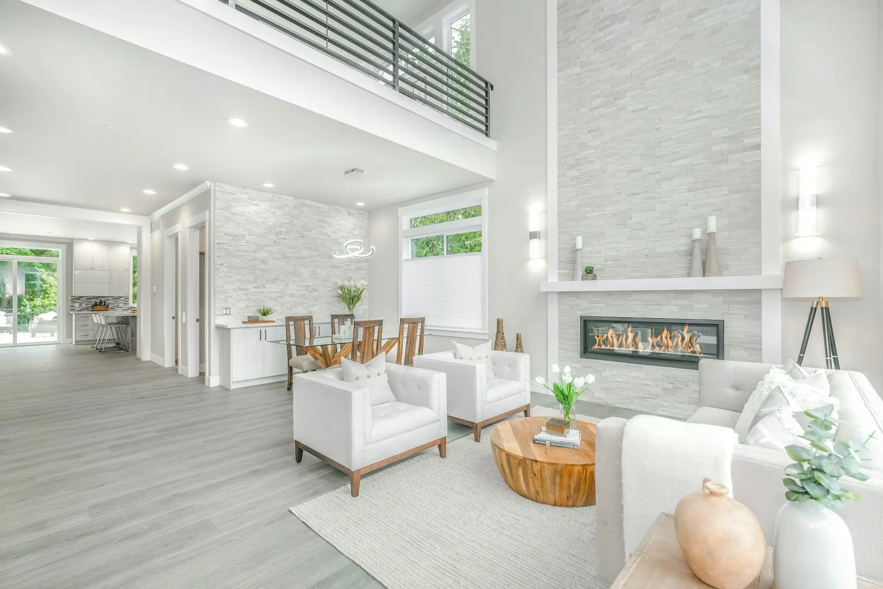 Bright double-height living room with a white fireplace